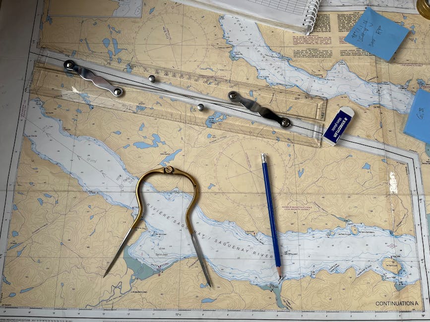 Flat lay of nautical chart with navigation tools including a compass, ruler, and pencil.